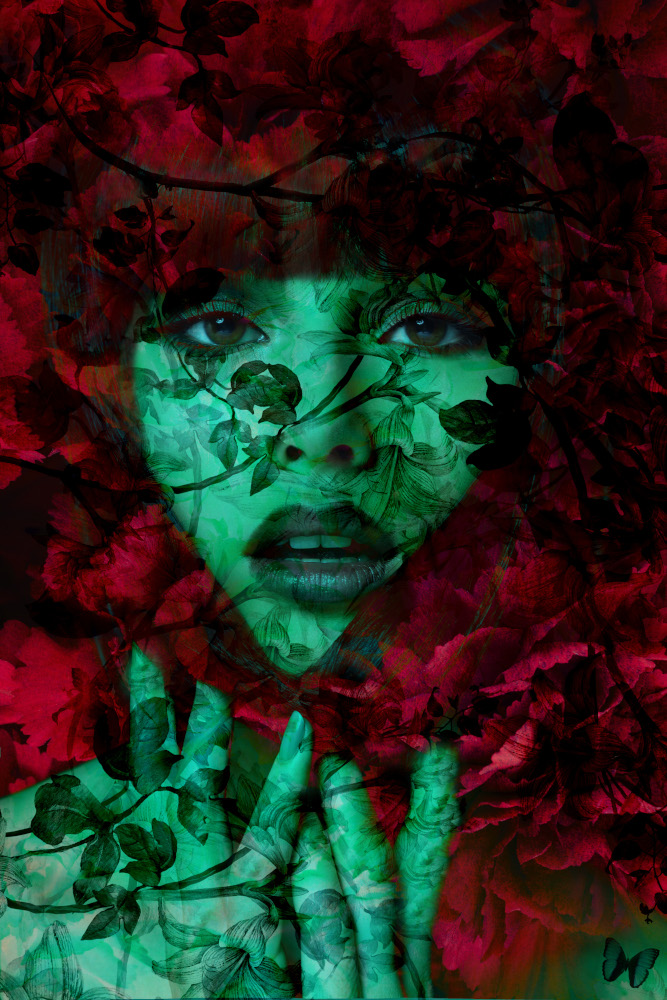 A woman with a face decorated in bright green and red flowers.